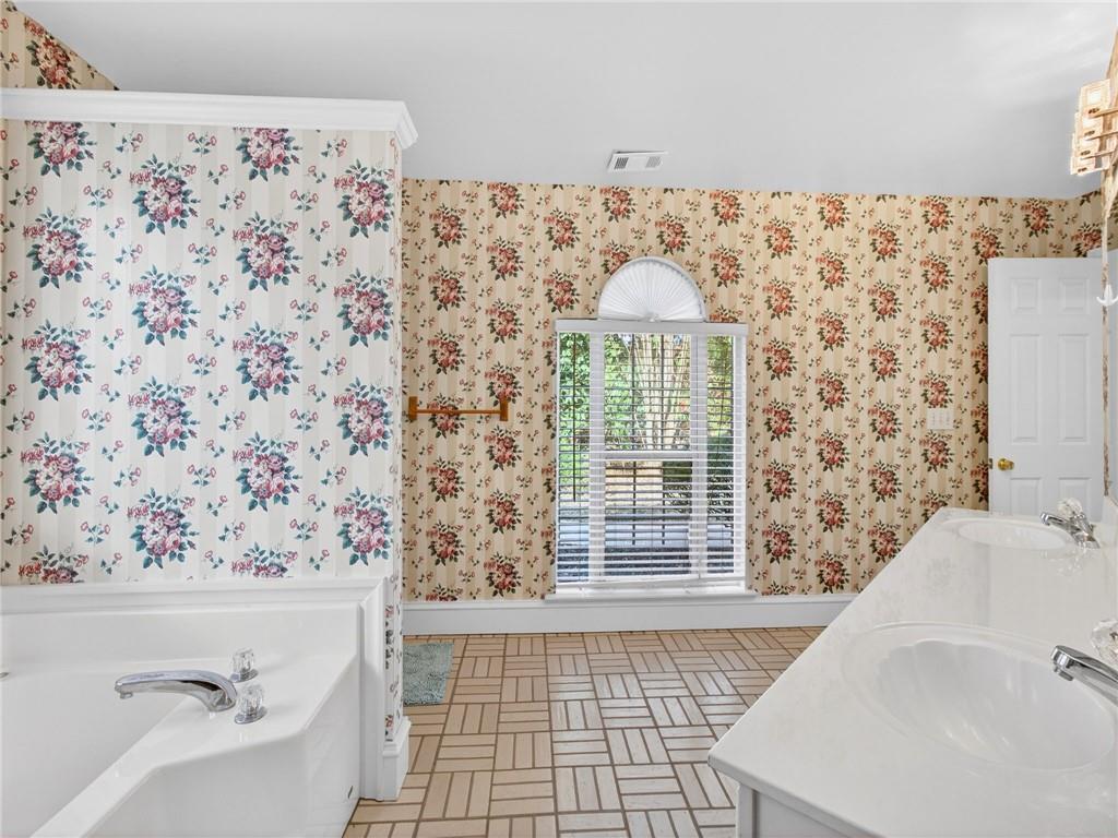 2038 Buford Dam Road Buford, GA 30518 - Photo 37 of 56 a bathroom with a bathtub and shower