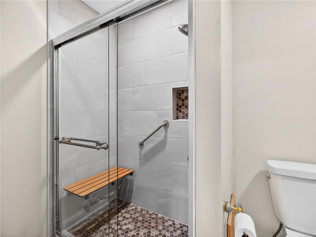 2038 Buford Dam Road Buford, GA 30518 - Photo 44 of 56 a bathroom with a shower and toilet