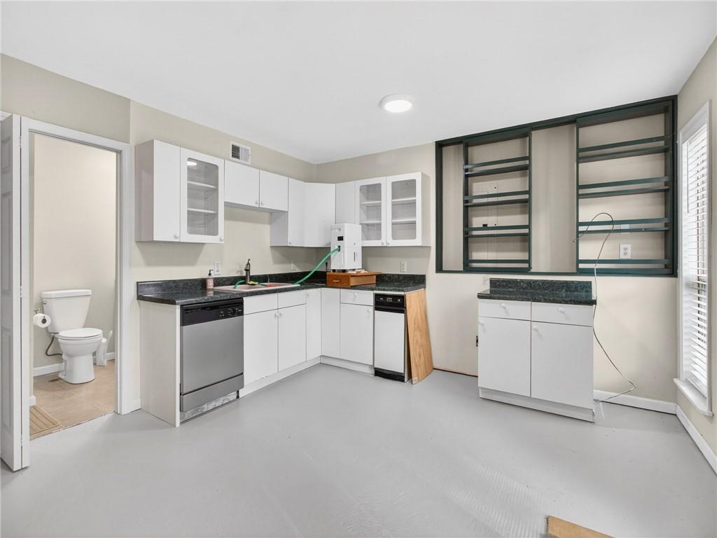 2038 Buford Dam Road Buford, GA 30518 - Photo 47 of 56 a kitchen with granite countertop white cabinets and white appliances