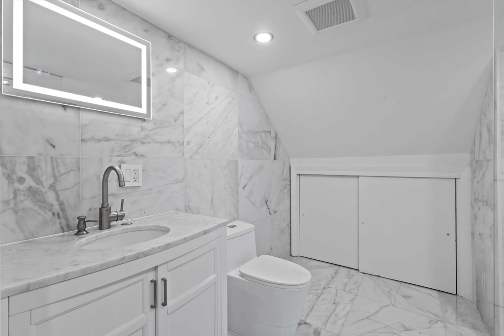 7 Darrow Street Worcester, MA 01606 - Photo 29 of 42 a bathroom with a sink a toilet and a mirror
