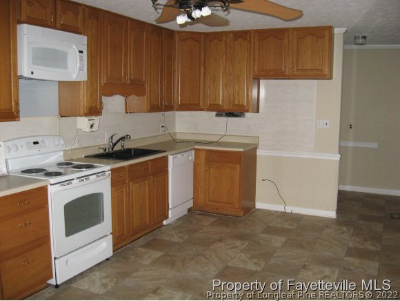 225 Cecil Avenue Spring Lake, NC 28390 - Photo 14 of 24 a kitchen with stainless steel appliances granite countertop a stove a sink and a refrigerator