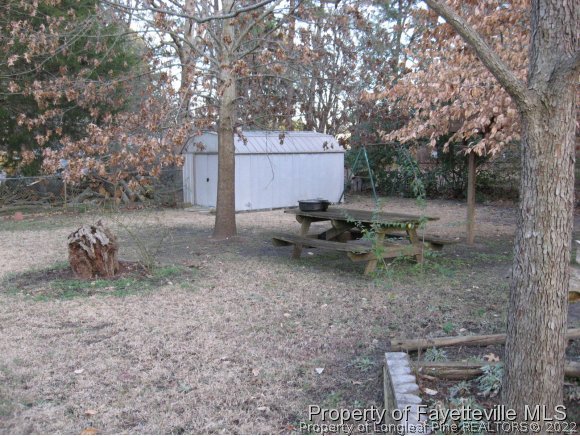 225 Cecil Avenue Spring Lake, NC 28390 - Photo 22 of 24 a backyard of a house with outdoor seating