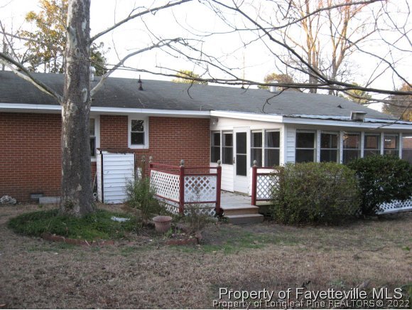 225 Cecil Avenue Spring Lake, NC 28390 - Photo 23 of 24 a view of a house with a yard and potted plants