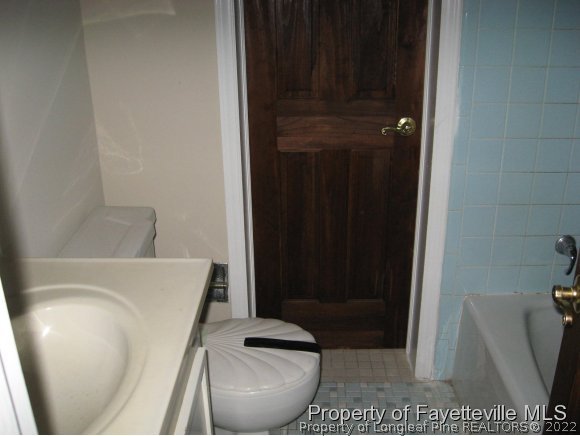 225 Cecil Avenue Spring Lake, NC 28390 - Photo 5 of 24 a bathroom with a toilet and a sink