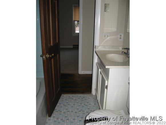 225 Cecil Avenue Spring Lake, NC 28390 - Photo 7 of 24 a bathroom with a sink and a mirror
