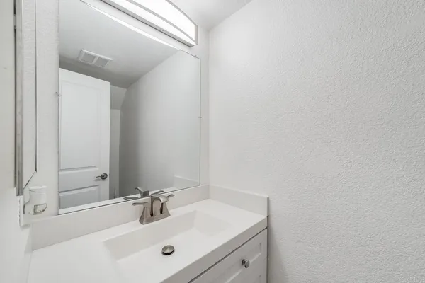 an empty room with a window and a ceiling fan