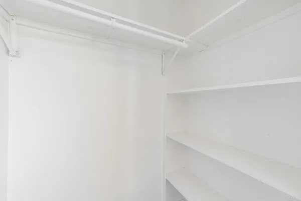 a view of a room with a ceiling fan