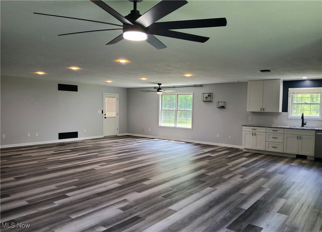 9415 Stone Road Litchfield, OH 44253 - Photo 6 of 28 Unfurnished living room with laminate flooring, recessed lighting, and ceiling fan