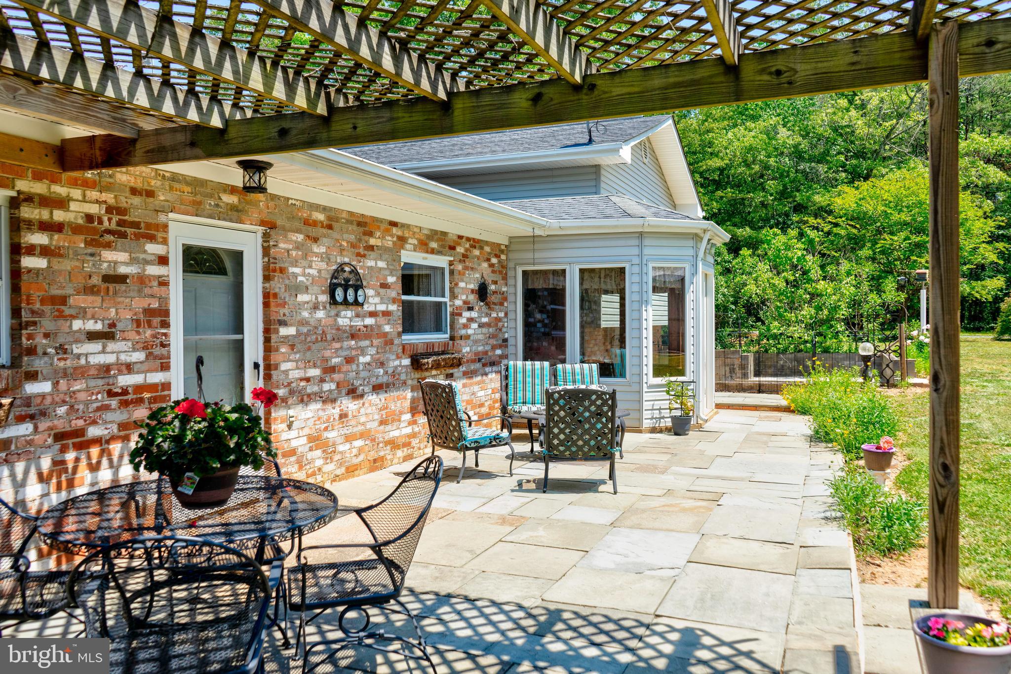 Slate patio with pergola-3 doors exit home to rear