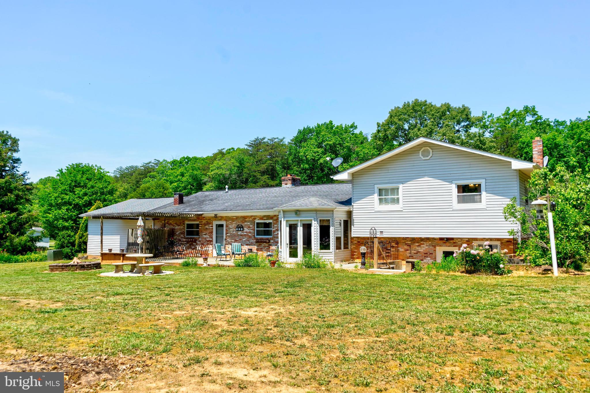 28484 Raccoon Ford Road Burr Hill, VA 22433 - Photo 27 of 48 Rear view of home-lovely established landscaping