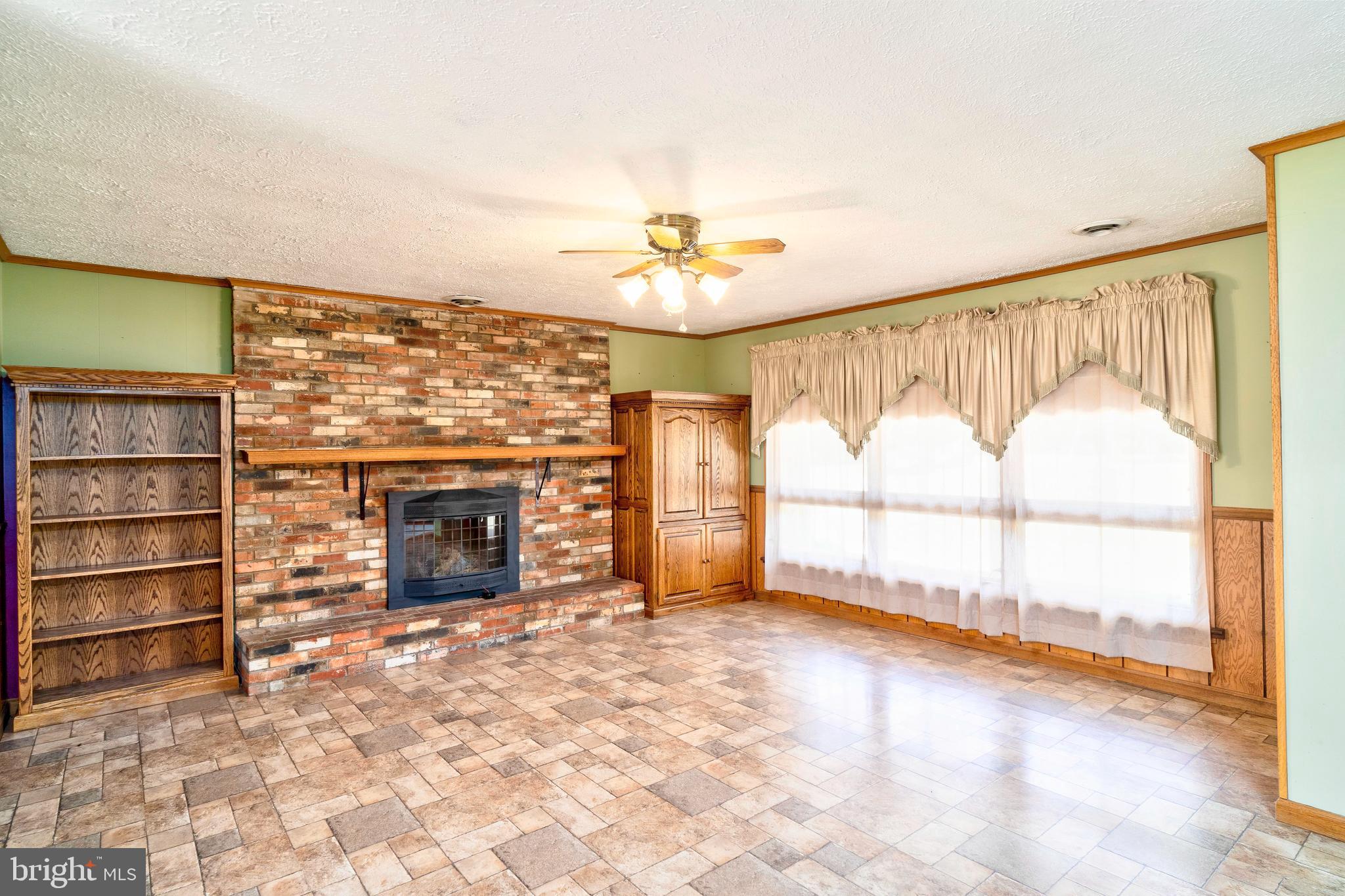 28484 Raccoon Ford Road Burr Hill, VA 22433 - Photo 10 of 48 Laminate flooring, brick FP, cabinetry conveys.