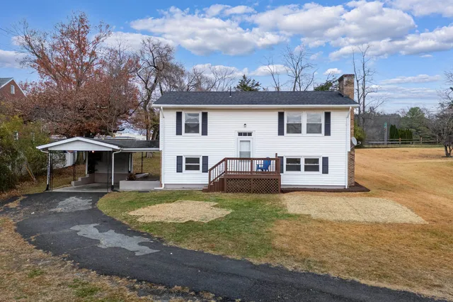 a view of a house with a yard balcony and furniture