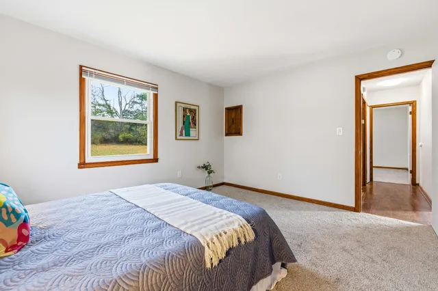 a bedroom with a bed and a painting on the wall