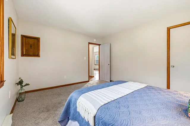 a bedroom with a bed and a potted plant