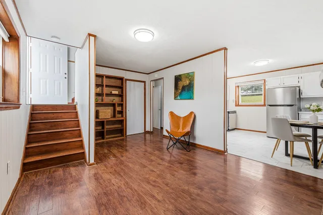 a view of a livingroom with furniture and staircase