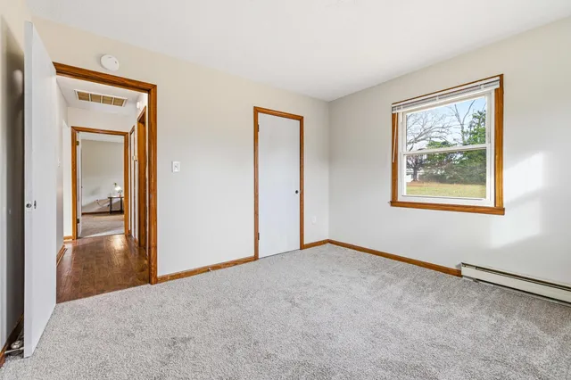 an empty room with windows and closet