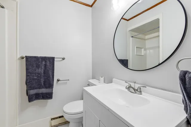 a bathroom with a sink a toilet and a mirror