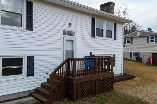 a view of a house with wooden deck