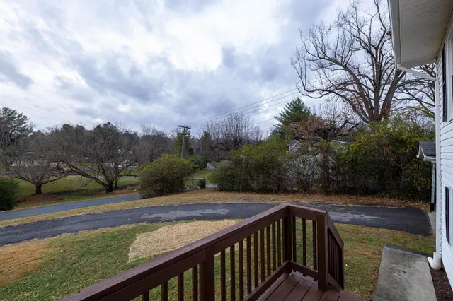 a view of backyard with wooden fence