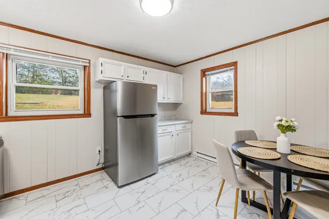 a kitchen with stainless steel appliances granite countertop a refrigerator and a stove top oven