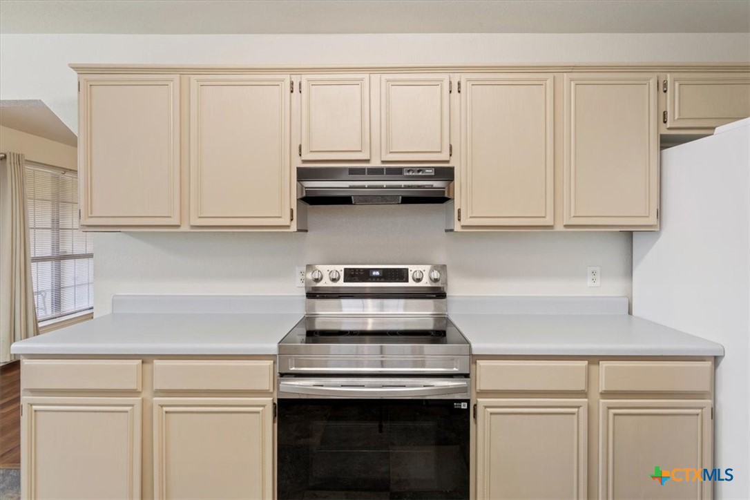 204 Rodeo Circle Copperas Cove, TX 76522 - Photo 12 of 28 a kitchen with granite countertop white cabinets and a stove