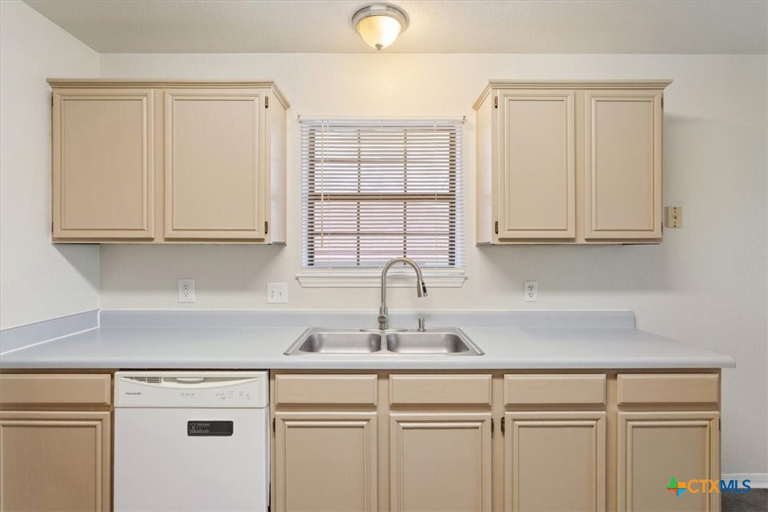 204 Rodeo Circle Copperas Cove, TX 76522 - Photo 14 of 28 a kitchen with stainless steel appliances granite countertop white cabinets sink and window