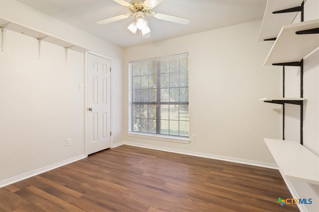 204 Rodeo Circle Copperas Cove, TX 76522 - Photo 23 of 28 an empty room with wooden floor fan and windows