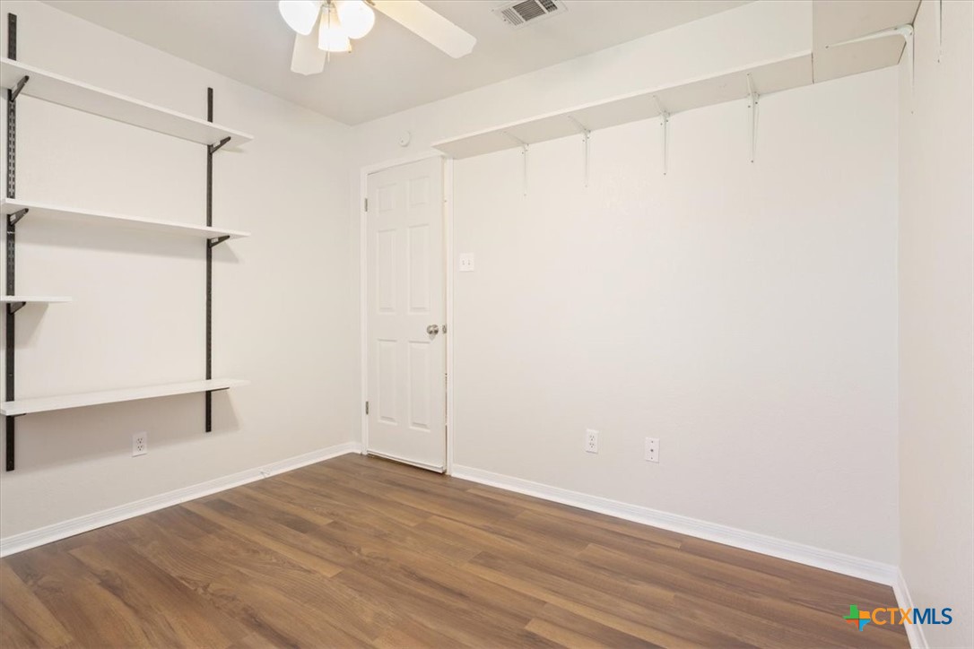 204 Rodeo Circle Copperas Cove, TX 76522 - Photo 24 of 28 a view of an empty room with wooden floor and a ceiling fan