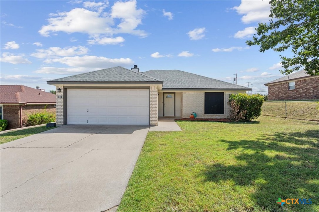 204 Rodeo Circle Copperas Cove, TX 76522 - Photo 3 of 28 a front view of a house with a yard and garage