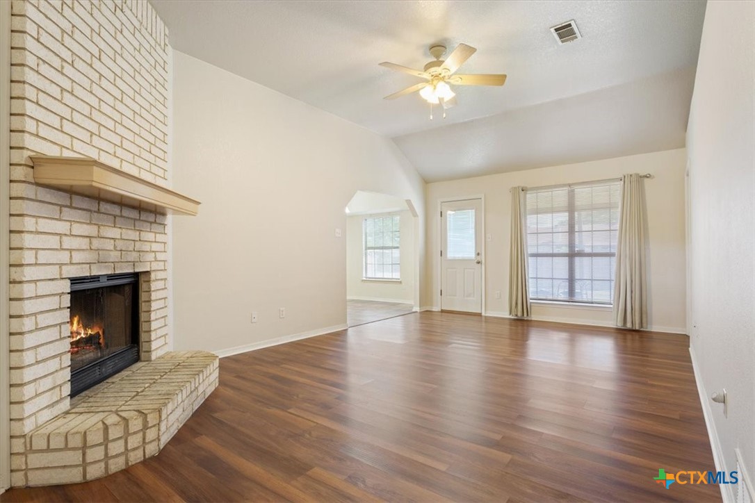204 Rodeo Circle Copperas Cove, TX 76522 - Photo 8 of 28 a view of an empty room with a fireplace and wooden floor