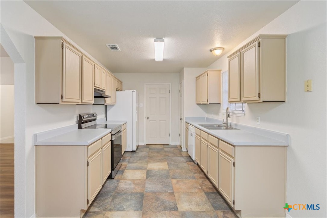 204 Rodeo Circle Copperas Cove, TX 76522 - Photo 10 of 28 a kitchen with stainless steel appliances granite countertop a sink and cabinets