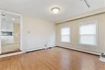 an empty room with a empty space and windows