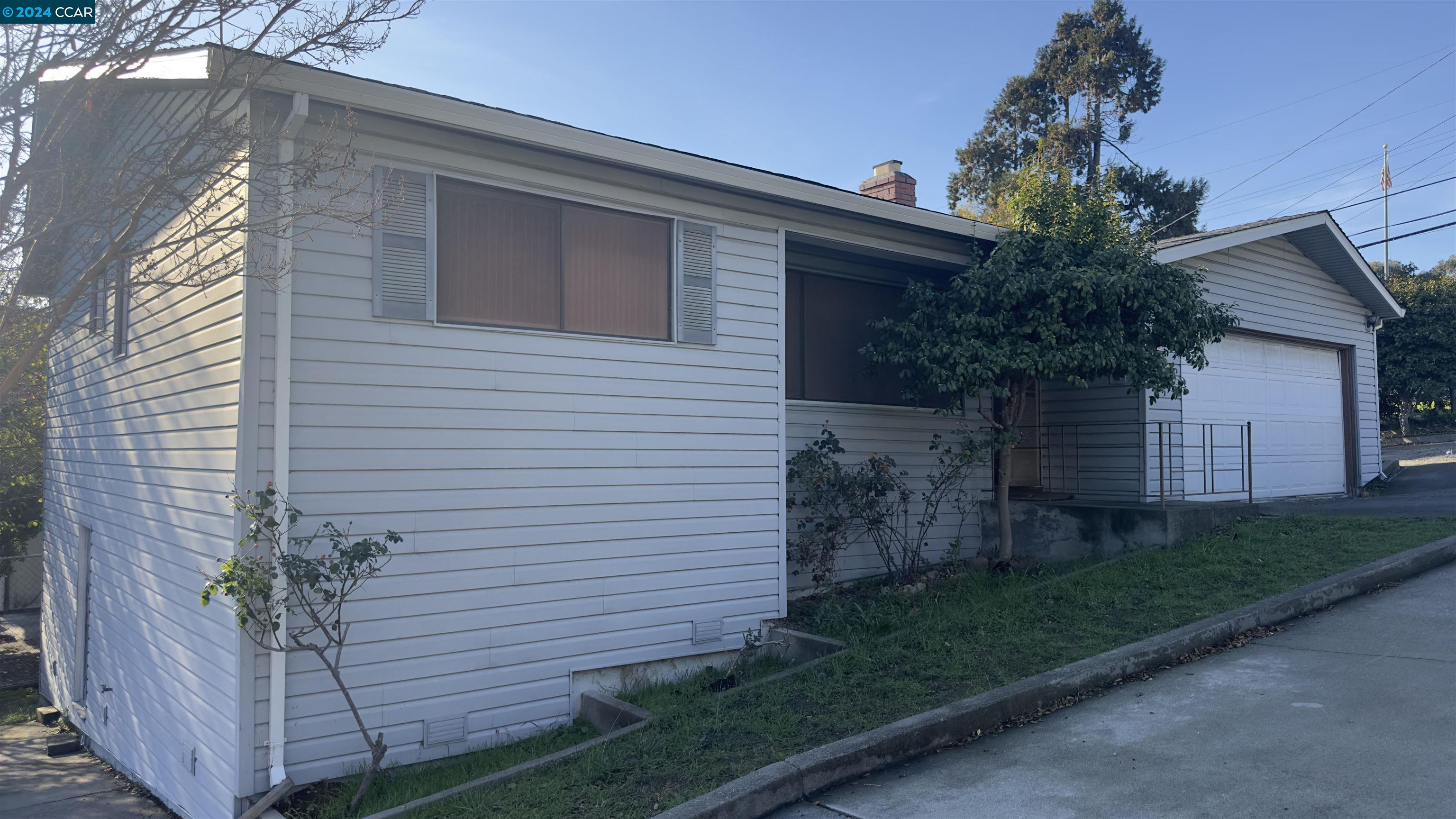 4200 Santa Rita Road El Sobrante, CA 94803 - Photo 1 of 1 a view of a house with a yard and potted plants