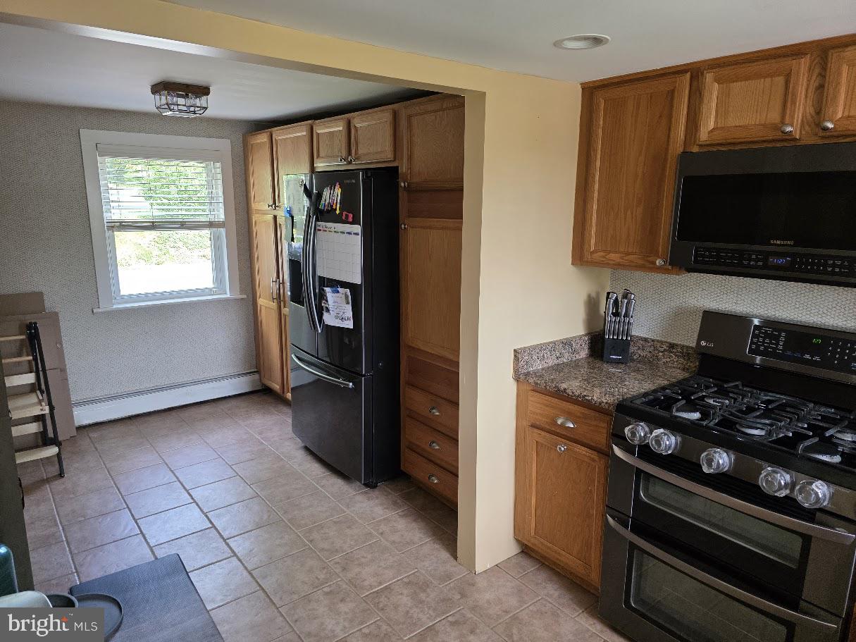 4903 Erie Road Harrisburg, PA 17111 - Photo 14 of 33 a kitchen with a stove and a microwave