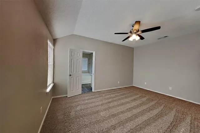 a view of empty room with ceiling fan