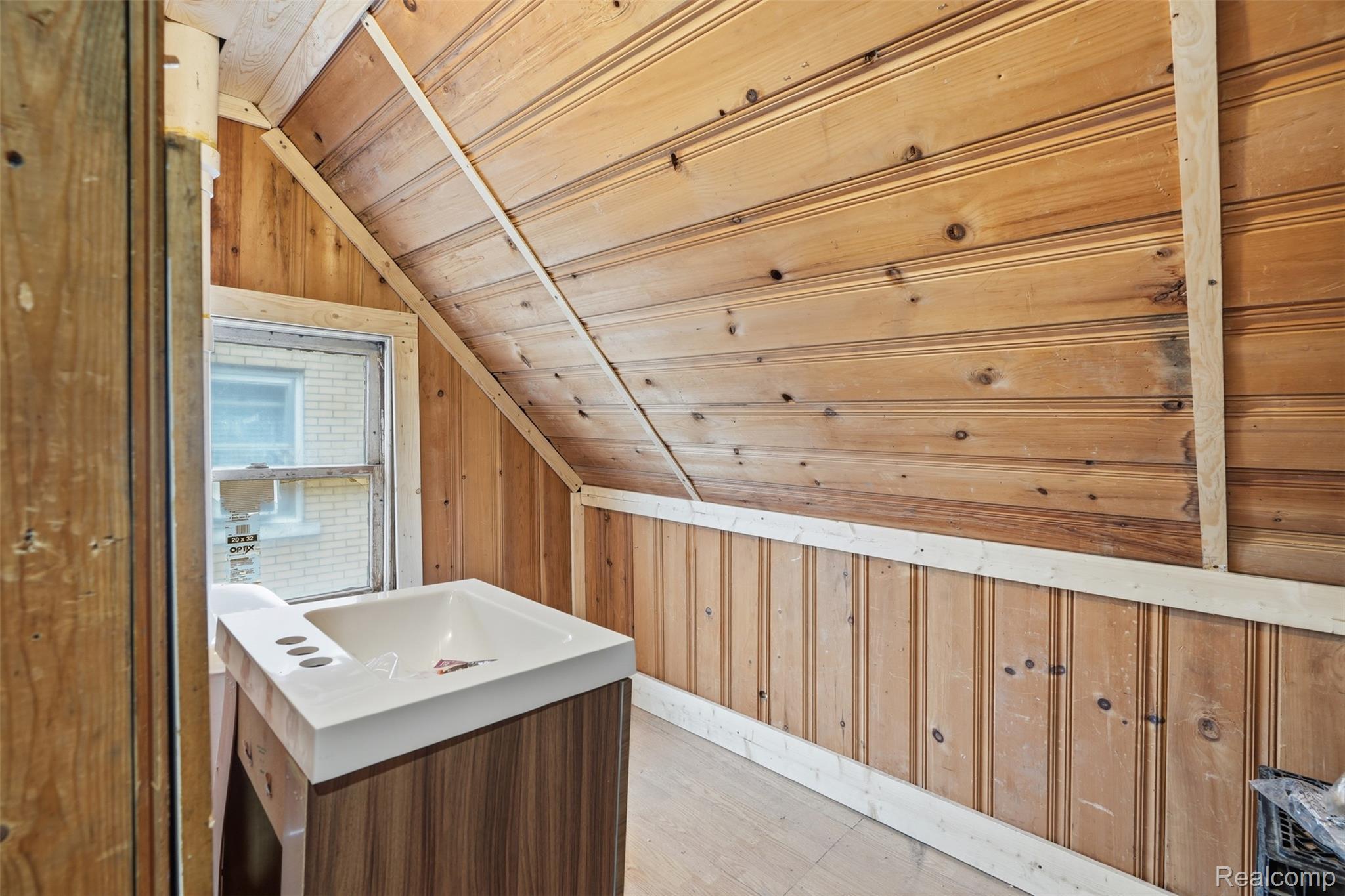 2500 Atkinson Street Detroit, MI 48206 - Photo 16 of 21 Bathroom with wooden walls, a vaulted wooden ceiling, vanity, and light wood-style flooring