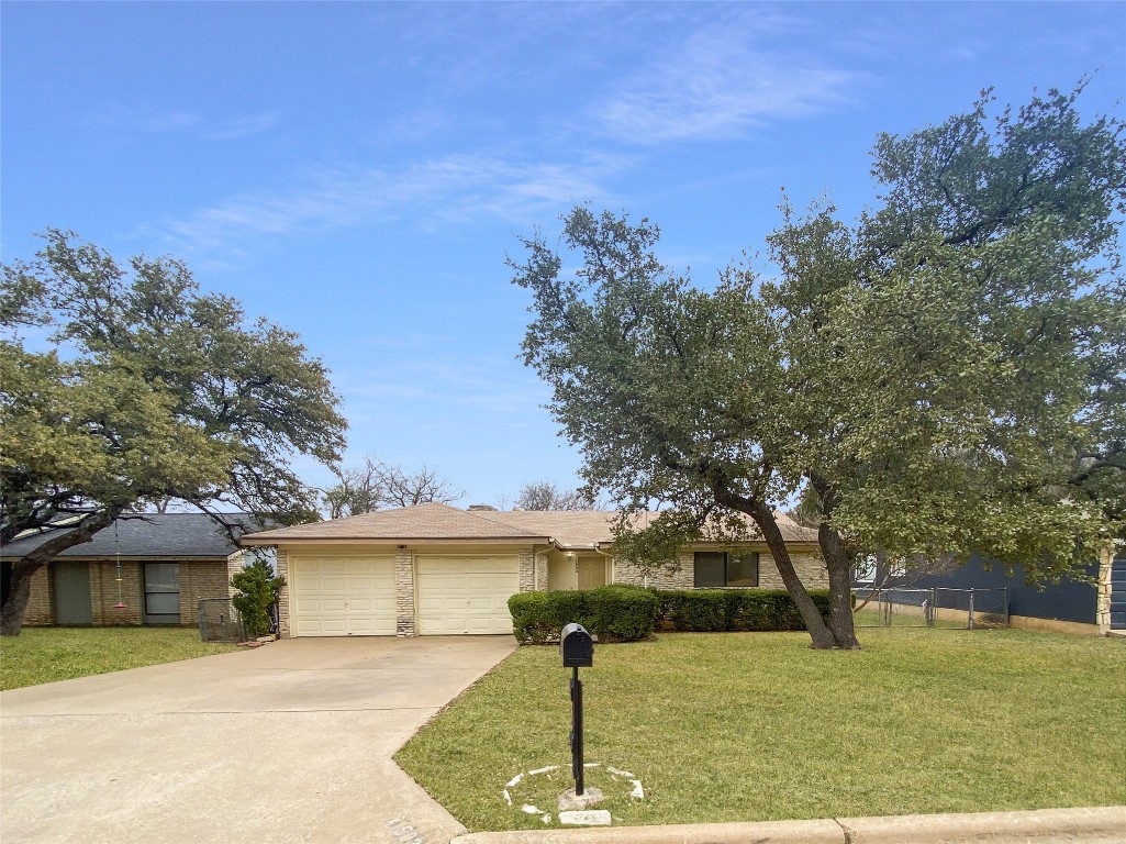 View of front of house featuring an attached garage and driveway