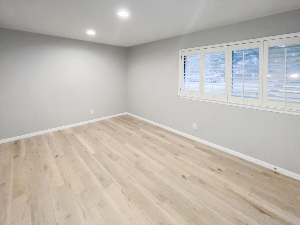 1503 Roundup Trail Round Rock, TX 78681 - Photo 11 of 23 Unfurnished room with light wood-style floors and recessed lighting