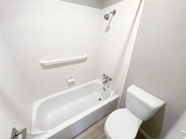 a bathroom with a toilet and bathtub