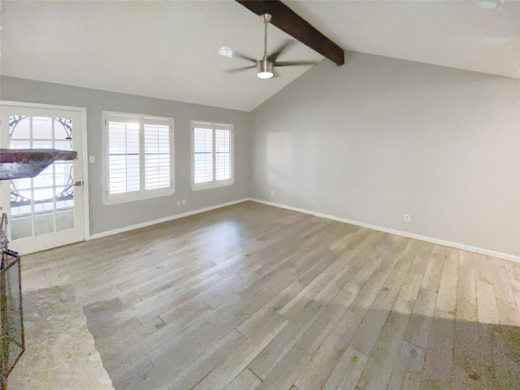 1503 Roundup Trail Round Rock, TX 78681 - Photo 5 of 23 Unfurnished living room featuring light wood-style floors and ceiling fan