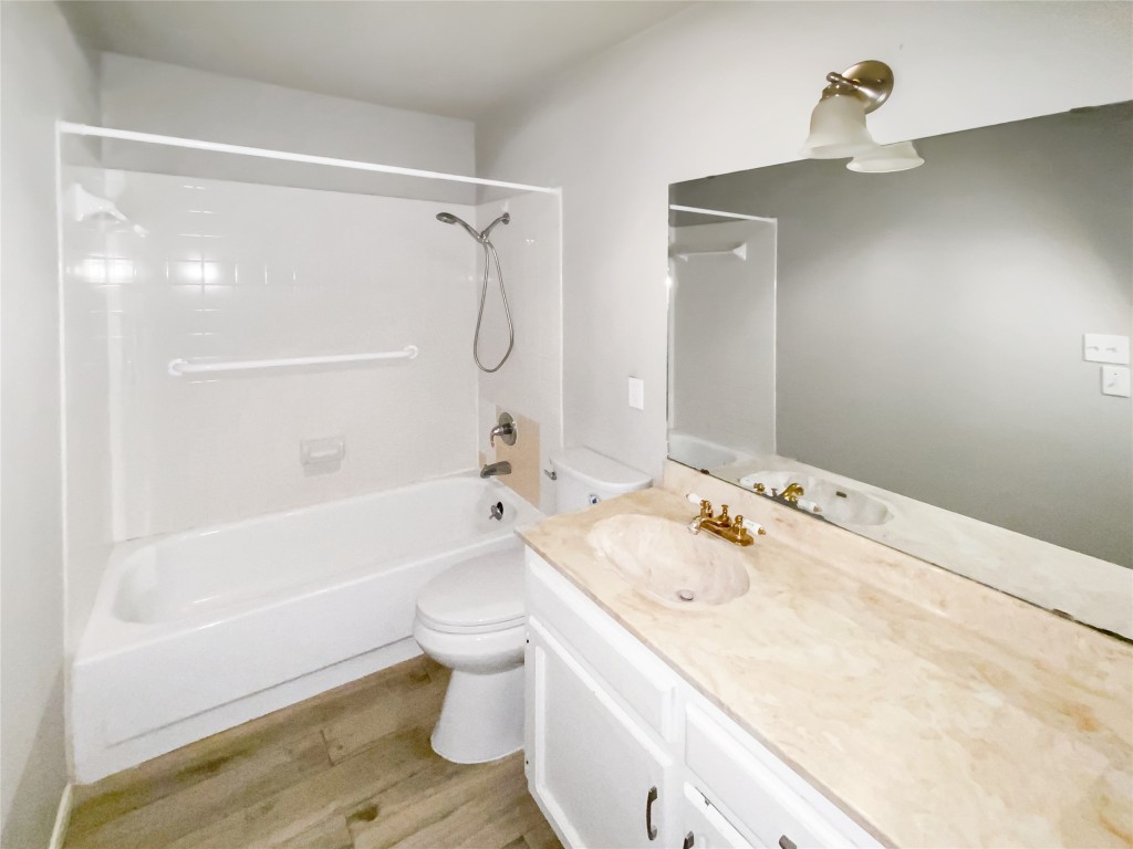 1503 Roundup Trail Round Rock, TX 78681 - Photo 10 of 23 Bathroom with tub / shower combination, vanity, and light wood finished floors