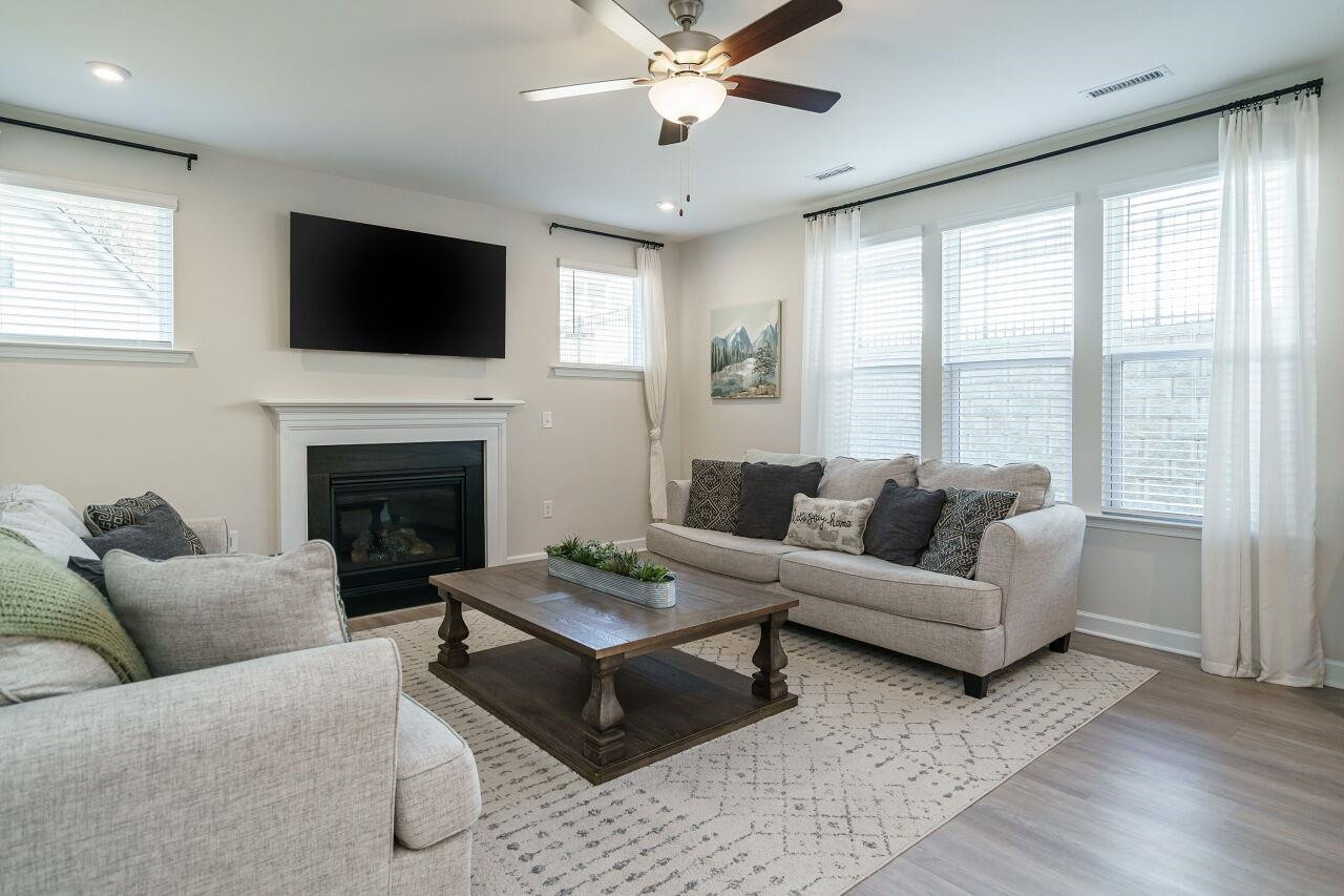 a living room with furniture fireplace and a flat screen tv