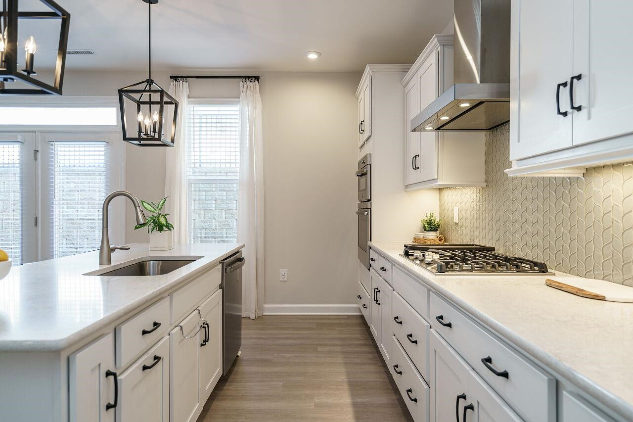 62 Maximus Circle Garner, NC 27529 - Photo 13 of 30 a kitchen with stainless steel appliances granite countertop a sink stove and refrigerator