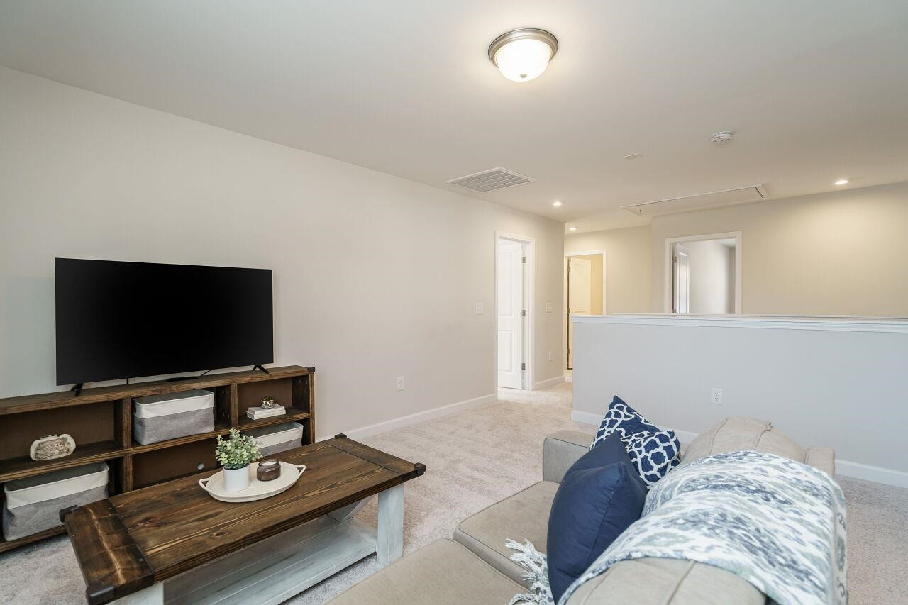 62 Maximus Circle Garner, NC 27529 - Photo 18 of 30 a living room with furniture and a flat screen tv