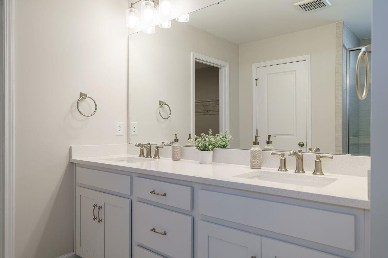 62 Maximus Circle Garner, NC 27529 - Photo 25 of 30 a bathroom with double vanity sink and a mirror