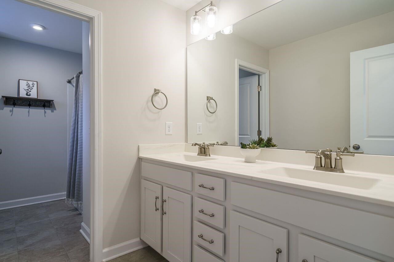 62 Maximus Circle Garner, NC 27529 - Photo 28 of 30 a bathroom with a double vanity sink and mirror