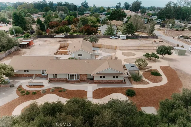 an aerial view of a house with yard swimming pool and outdoor seating