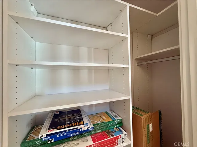 a view of a storage & utility room with two washing machine