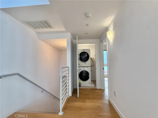 a view of kitchen and hallway with wooden floor