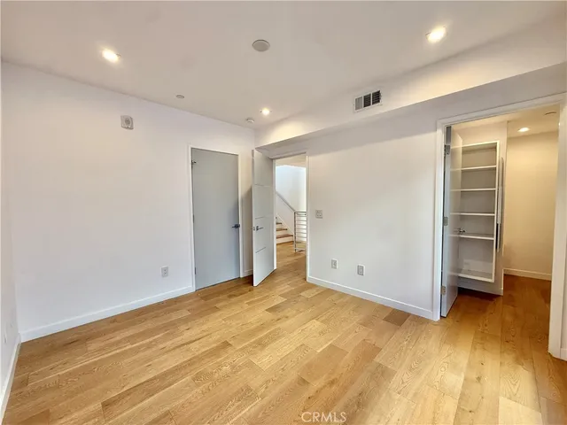a view of walk in closet and bedroom view